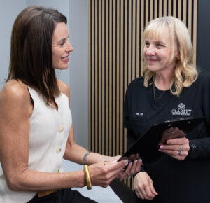 A provider smiles with a patient before administering ‌lip filler near Liberty, MO.