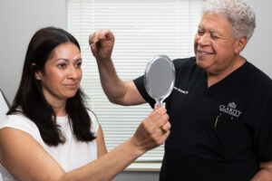 A woman examines her results after receiving a treatment for reducing marionette lines in Kansas City.