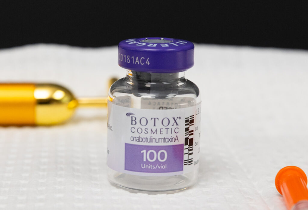 A vial of masseter Botox near Parkville, MO, sitting on a treatment table in Clarity Heath & Aesthetic treatment room, ready to be used for a patient's treatment plan.